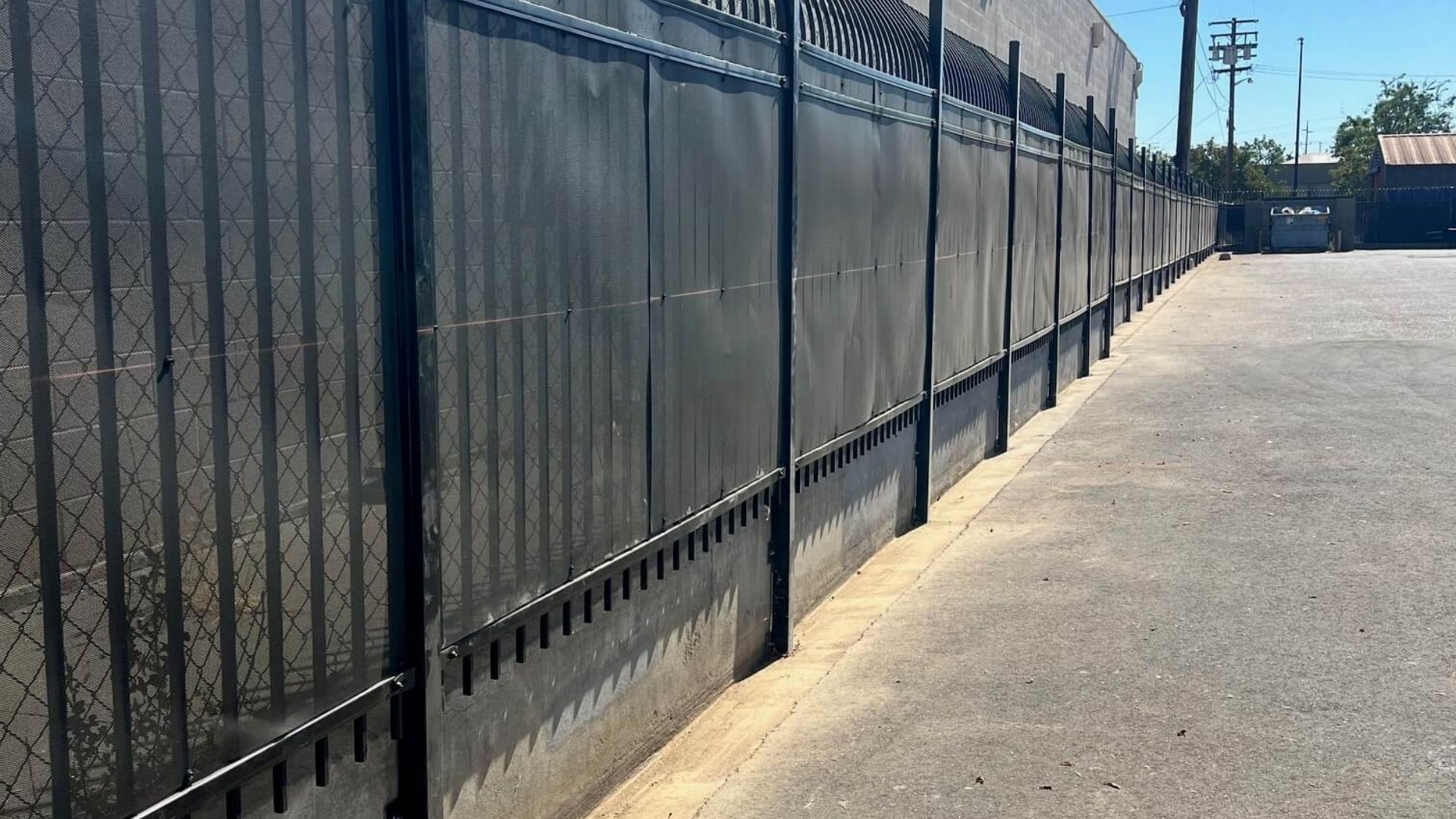 Iron perimeter security fence with privacy screening at Hannah’s House